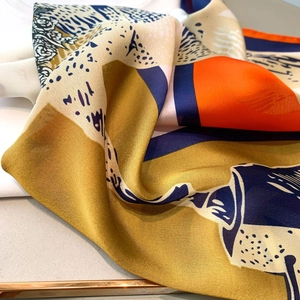 Macro shot of abstract color-block square scarf with mustard yellow and navy blue silk texture