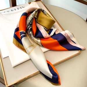 Detailed close-up of a 70x70cm square silk scarf with tiger and geometric print patterns