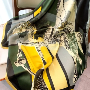 Close-up of a satin silk scarf with colorful horse print on a wooden chair