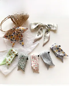 Detailed view of various artistic tie-dye twilly silk scarves with unique floral patterns