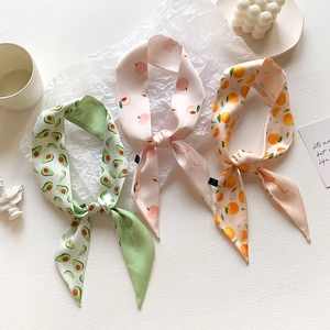 Detail of soft satin ribbons with cute fruit prints including avocado and peach designs