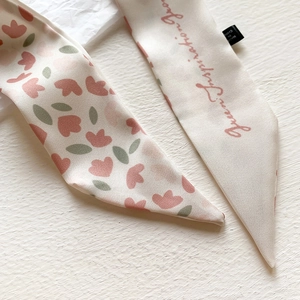 Detail of floral printed twilly scarf with pink flowers and Green Inspiration text
