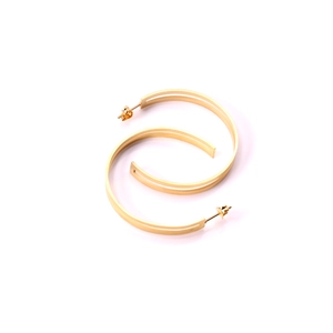 Detail view of double-layer hollow golden hoop earrings with a minimalist geometric design