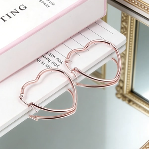 Elegant rose gold heart hoop earrings for women with mirror finish and stylish metal design