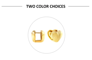 Detail of gold heart huggie earrings with vertical textured finish and secure clasp