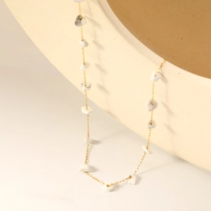 Gold chain necklace with irregular white stones in a minimalist Bohemian design