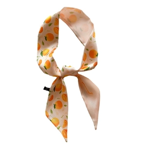 Chic skinny silk-feel scarf featuring bright orange fruit and green leaf prints