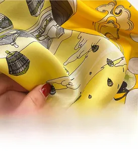 Detailed macro view of digital print silk scarf with classic yellow architectural patterns