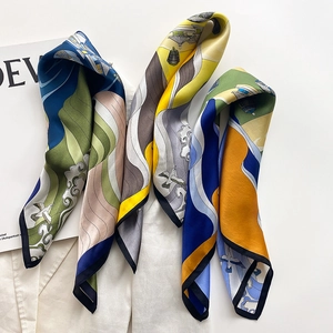 Close-up of silk scarves with vintage mountain patterns on white suit blazer