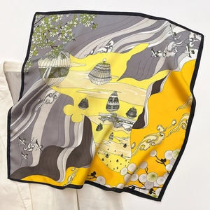 Detail of yellow and gray printed silk scarf with floral landscape patterns on white shirt