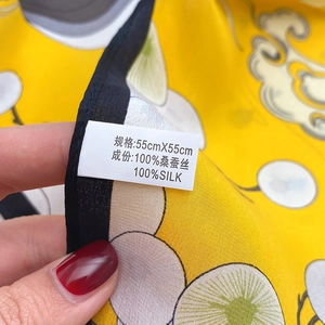 Detail of 100% mulberry silk scarf washing label and 55x55cm size specification