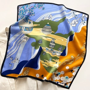 Detailed close-up of a silk square scarf with crane and floral prints on a blazer