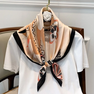 Elegant floral silk-feel square scarf with geometric dots tied on a white T-shirt