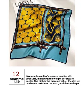 Detail of 12 momme silk square scarf featuring vibrant yellow floral patterns and high density texture
