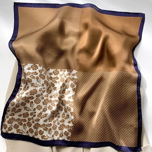 Detailed view of silk square scarf featuring vintage geometric patterns and satin edges