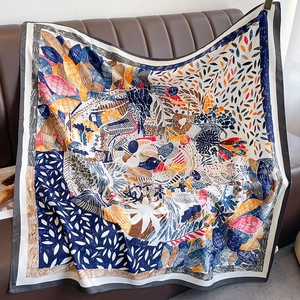 Detailed view of colorful floral beach scarf draped on a leather sofa with fine edges