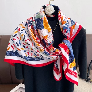 Detailed view of lightweight red floral silk scarf with vibrant abstract print