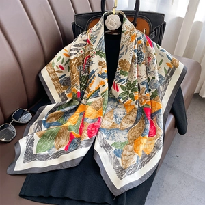 Red vintage floral silk scarf with colorful botanical prints draped over a black outfit