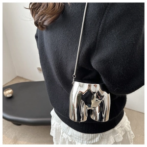 Creative mirror silver body-shaped crossbody bag with a sleek metal chain on a model