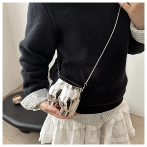 Detail of silver mirror finish bum-shaped crossbody bag with slim metal snake chain