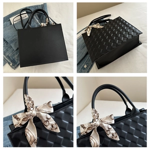 Detail of black rhombic quilted tote bag featuring a silk scarf wrapped handle
