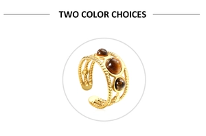 Detail of three brown tiger eye stones set in a triple-layered spiral gold ring