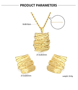 Detail of gold-plated jewelry set with wavy textured pendant and twisted chain link