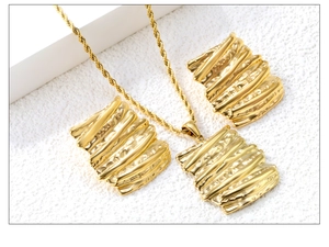 Detail of golden rectangle pendant and earrings with liquid metal bark texture
