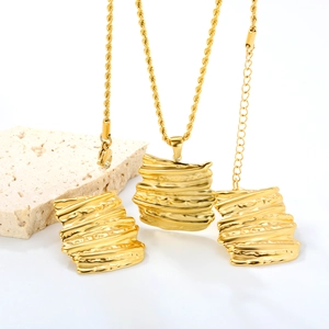 Golden bark textured jewelry set with wavy pendant necklace and matching earrings