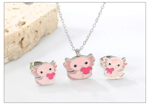 Close-up of pink axolotl pendant and earrings set with red heart details