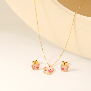 Pink enamel axolotl necklace and earrings set in gold-tone minimalist jewelry display