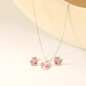 Cute pink axolotl jewelry set with necklace and stud earrings holding a red heart