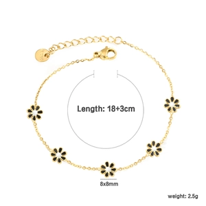 Detail of 18K gold-plated daisy bracelet with black and white enamel flower charms