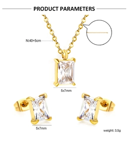 Macro view of gold stainless steel necklace and earring set with square zircon pendants