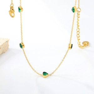 Elegant gold choker necklace featuring five green heart zircon gemstones on a fine chain
