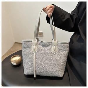 Détail du cabas en faux mouton gris avec anses en cuir lisse pour un usage quotidien