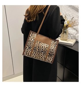 Detail of vintage leopard print tote bag with brown straps and spacious interior design