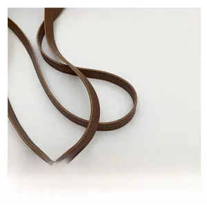 Close-up of brown faux leather shoulder strap with neat stitching on leopard tote bag