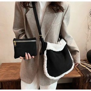 Detail of black faux suede shoulder bag with white Sherpa trim and matching small pouch