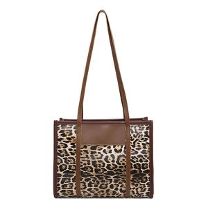 Leopard print large tote bag with brown leather handles and vintage crossbody design