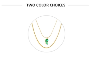 Close-up of double-layer gold chain necklace with green leaf pendant and marquise zircons