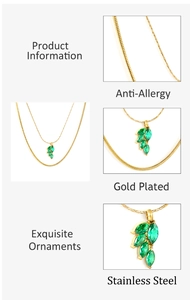 Detail view of gold plated leaf necklace with green stones and anti-allergy features
