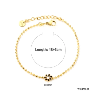 Detail of 18K gold plated stainless steel bead bracelet with black and white flower charms
