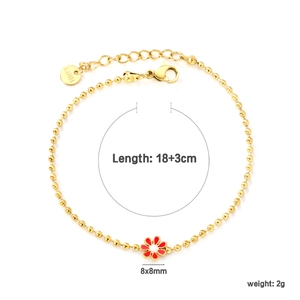 Detail of gold ball chain bracelet with red flower pendant and adjustable clasp