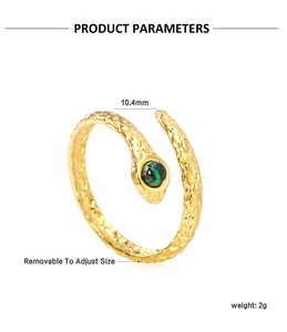 Detailed macro view of gold snake ring featuring green stone and adjustable open band