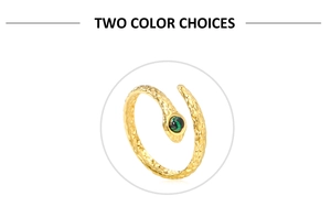 Detail view of gold snake ring featuring textured scales and green gemstone setting