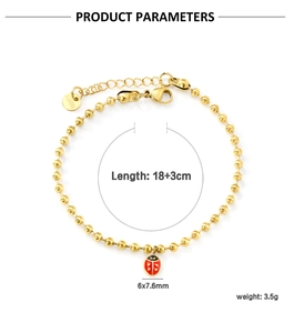 Détail du charm coccinelle et gravure S. STEEL sur bracelet à billes en acier doré