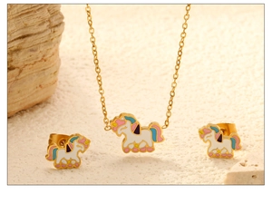 Detail of children's unicorn jewelry set with colorful enamel pendants on a textured surface