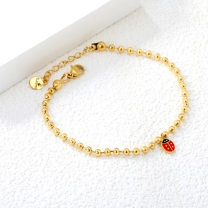 Bracelet à billes en acier inoxydable doré avec un joli pendentif coccinelle émaillé