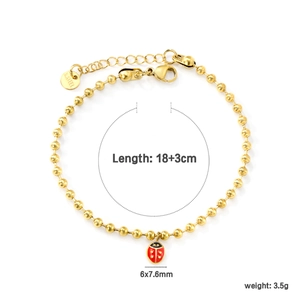 Bracelet à billes en acier inoxydable doré avec breloque coccinelle en émail rouge